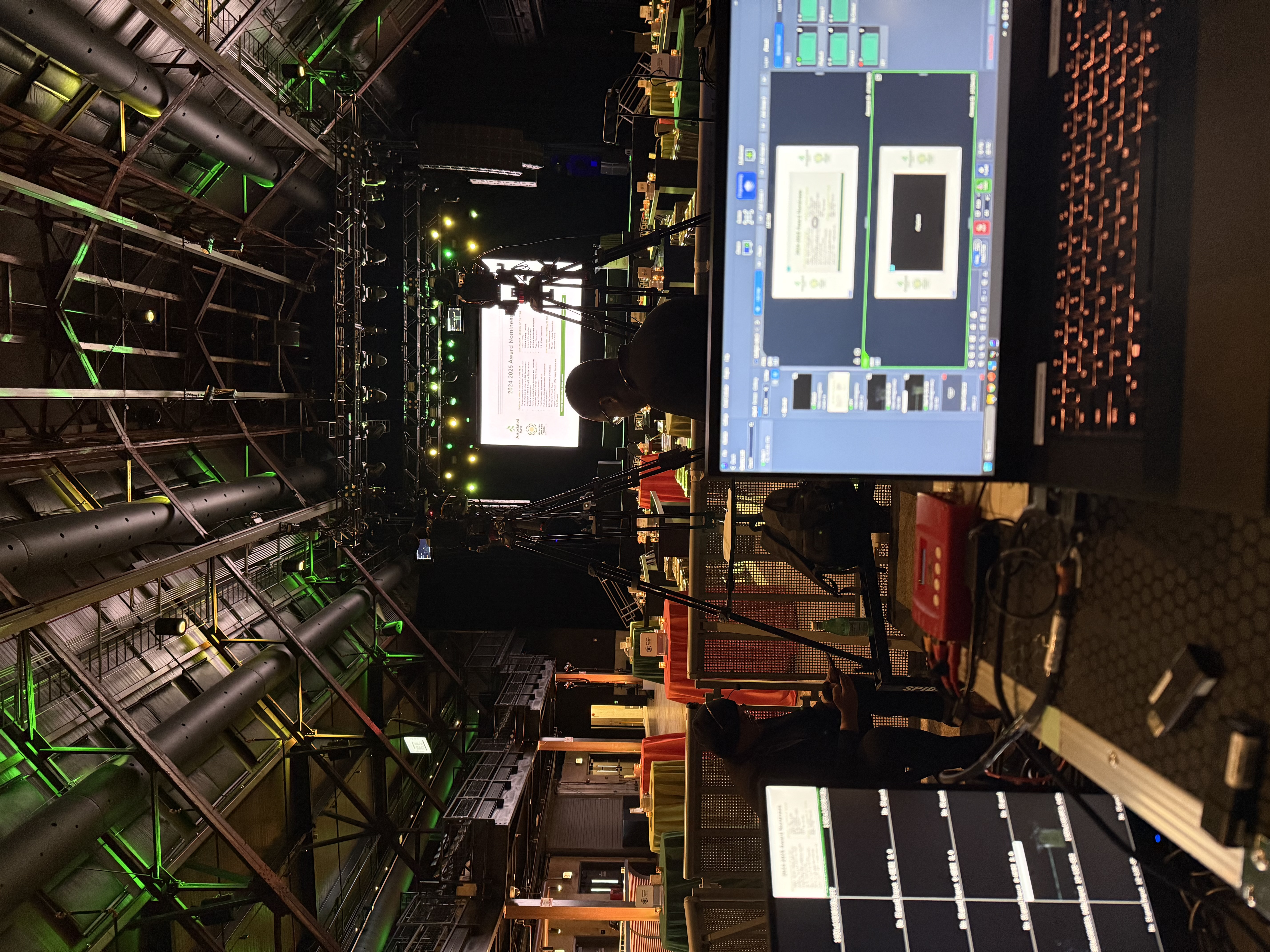 Interview production set with cameras, soft lighting, and broadcast graphics
